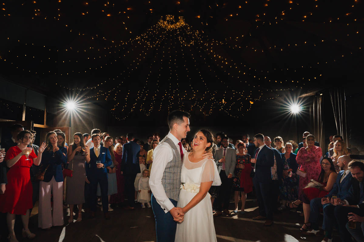 the newly-weds share their first dance on the dance floor at wick farm