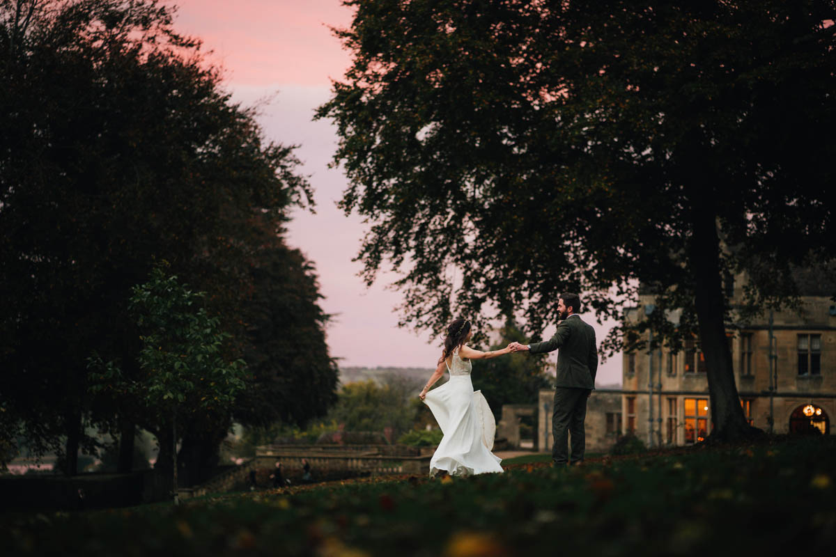 the newly-weds dance outside Coombe lodge as the sun sets