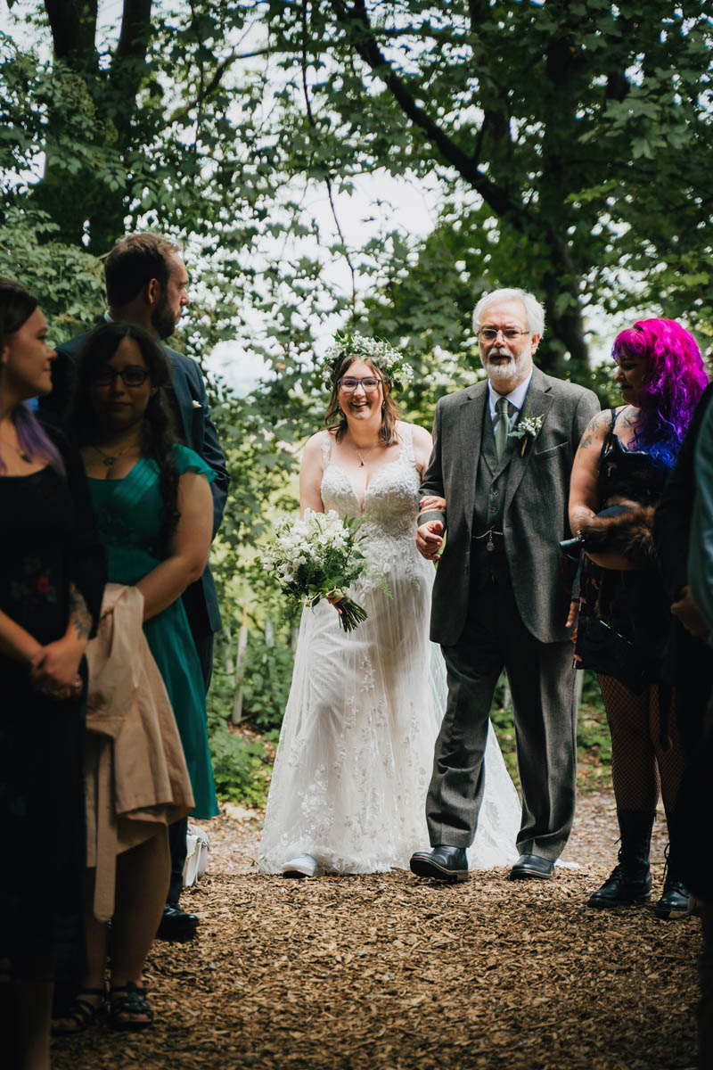 the father of the bride walks his daughter down the aisle of the underwood centre