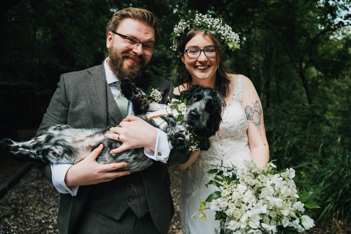 bridal portrait of the bride, groom and their cocker spaniel dog
