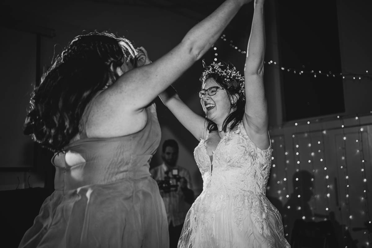 bride dances joyfully with her bridesmaid