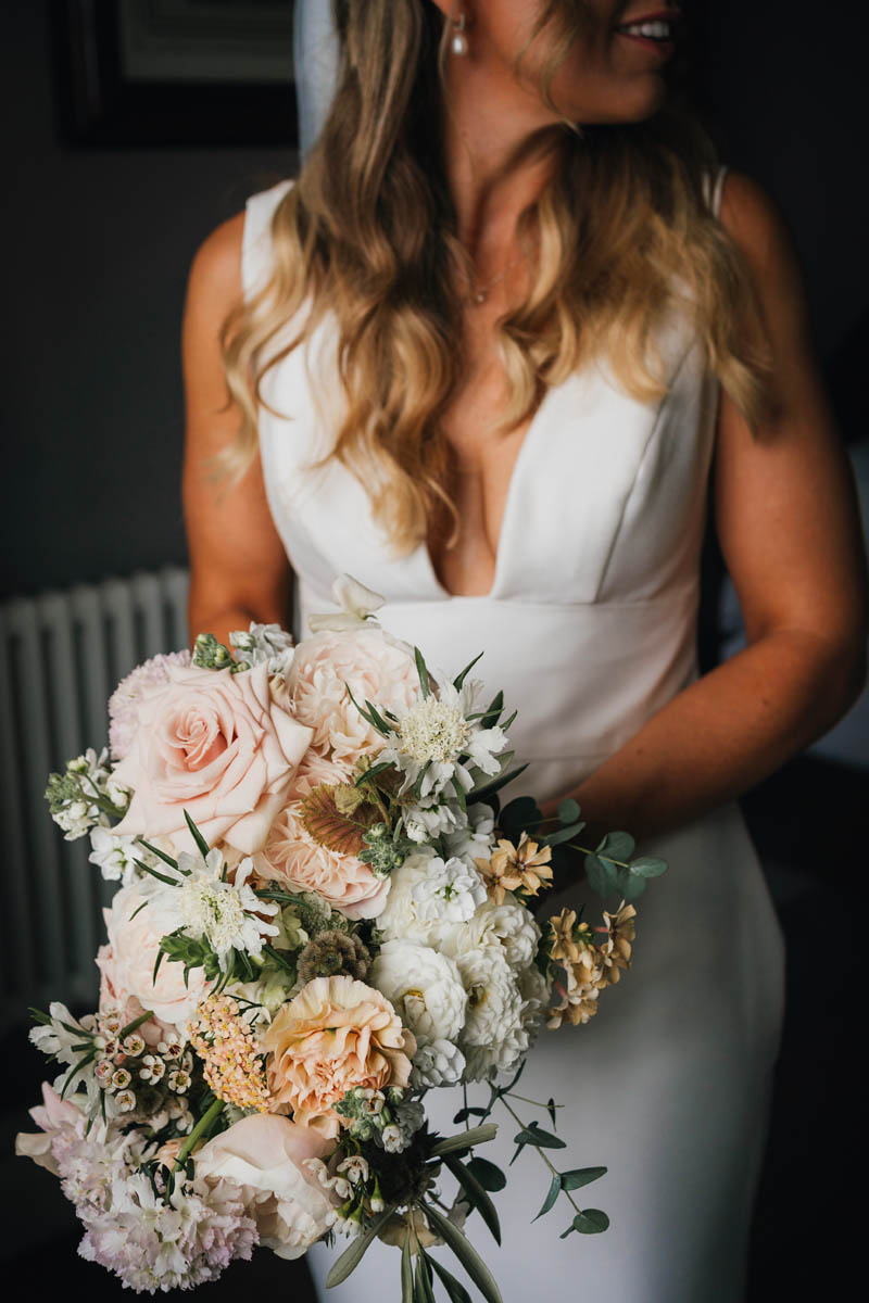 the bride holds her bridal bouquet