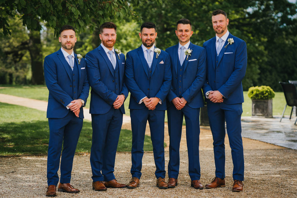 the groom and his groomsmen posing for the camera