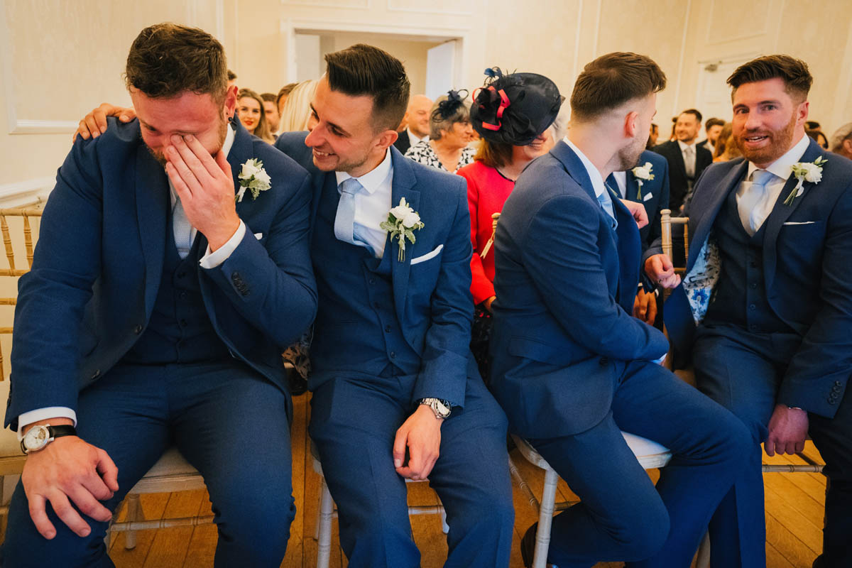 groomsmen get emotional during the wedding ceremony