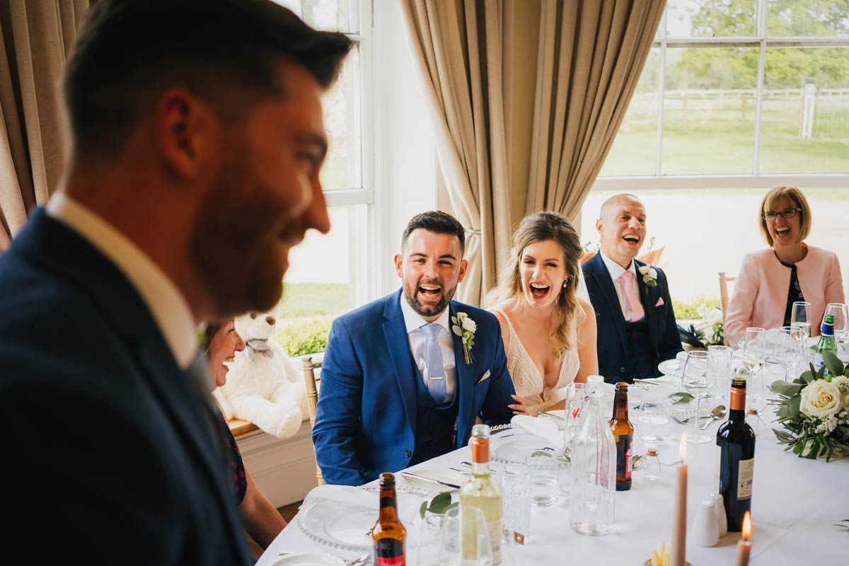 the top table exploding in laughter during the best man's speech