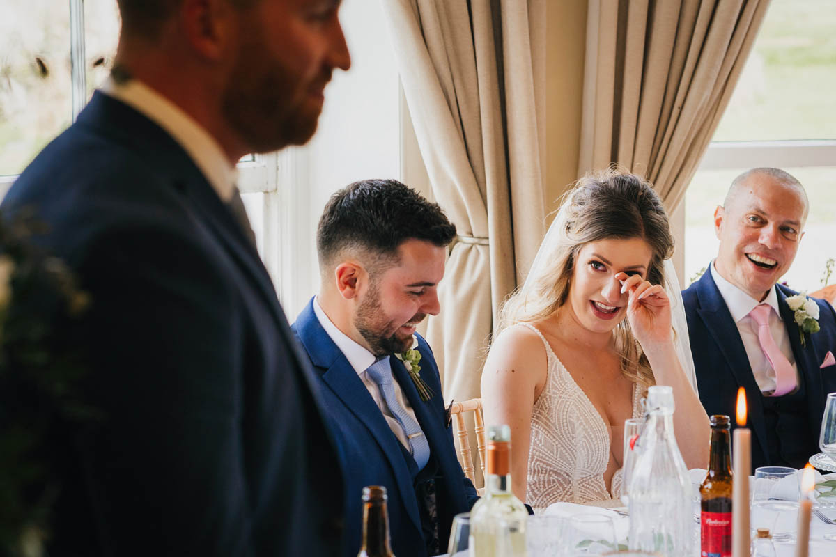 the bride shares a tear during the best man's speech