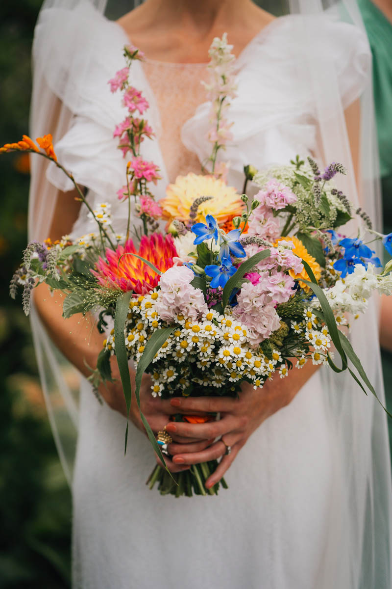 the bridal bouquet with spring flowers including dairies and forget-me-nots