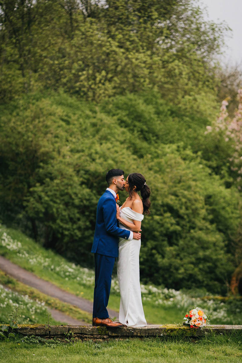 newly-weds kiss in the garden at hilles house