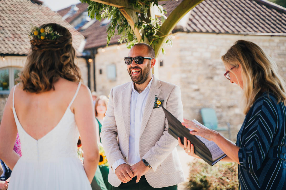 the groom laughing during the ceremony