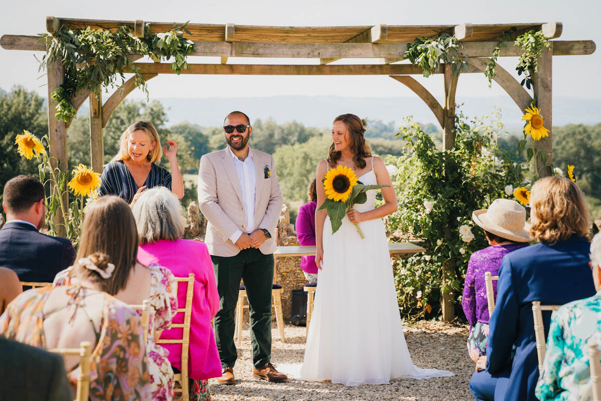 the wedding ceremony outside with views over the mendip hills behind