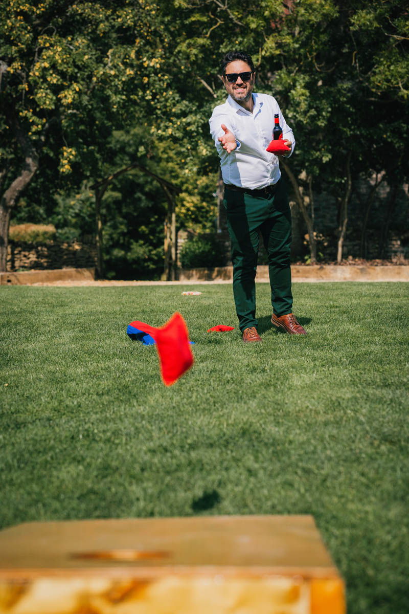 a man throws a beanbag