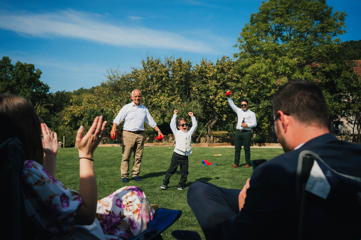 a young boy with his father and grandfather celebrate during a game