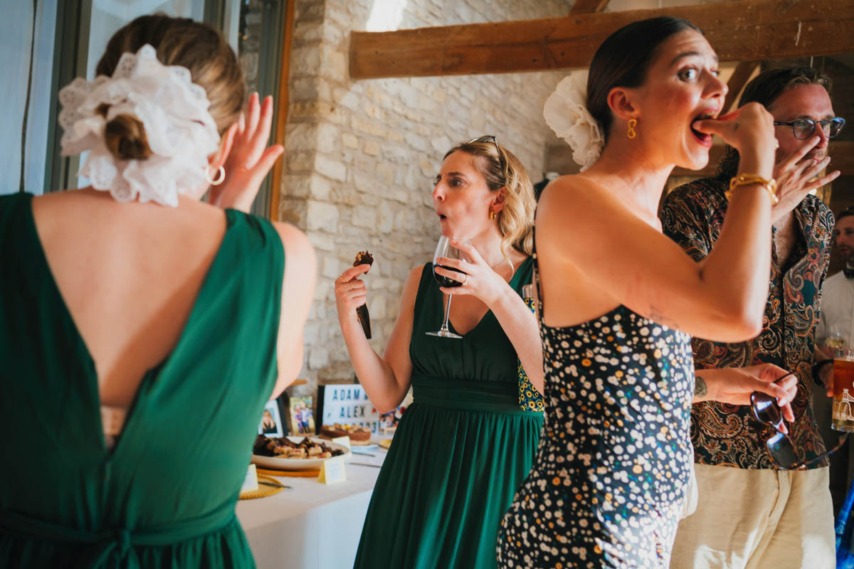 wedding guests enjoy cake in the atrium