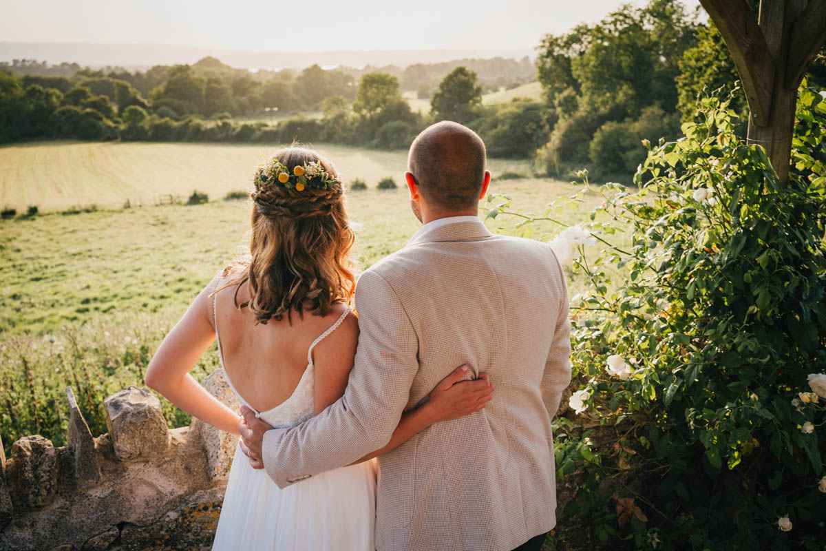 bride and groom looking out at the view over the chew valley