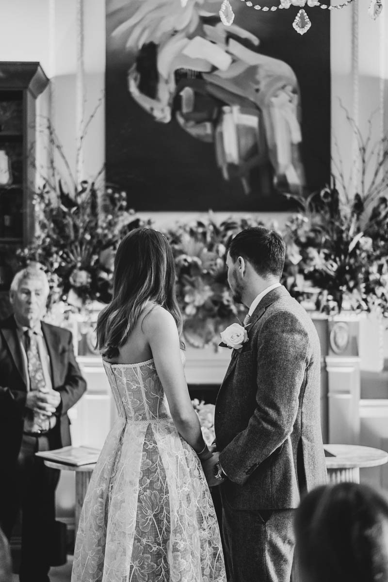 the newly-weds look on at the registrar as he leads the ceremony