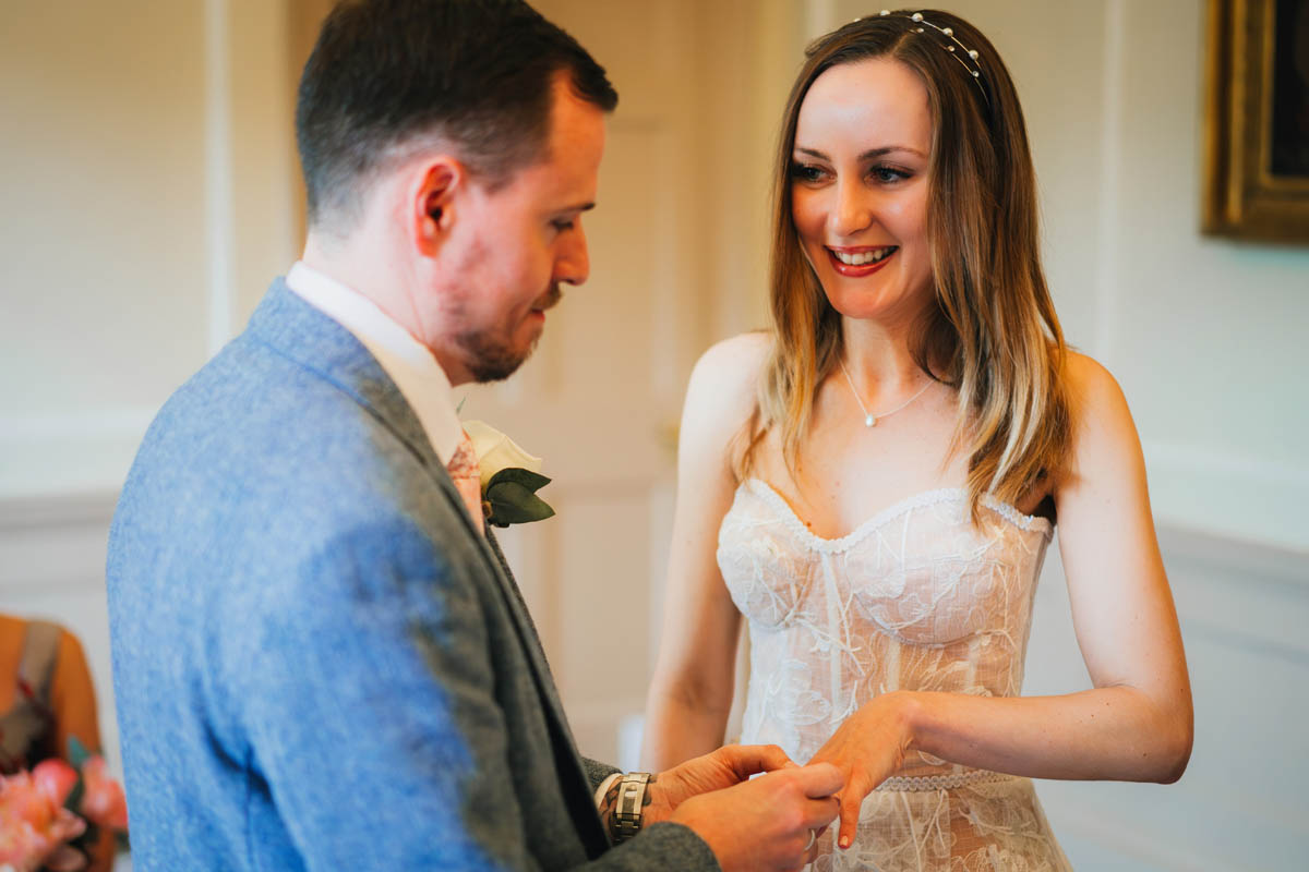 exchanging of the wedding rings, the bride smiles at her husband