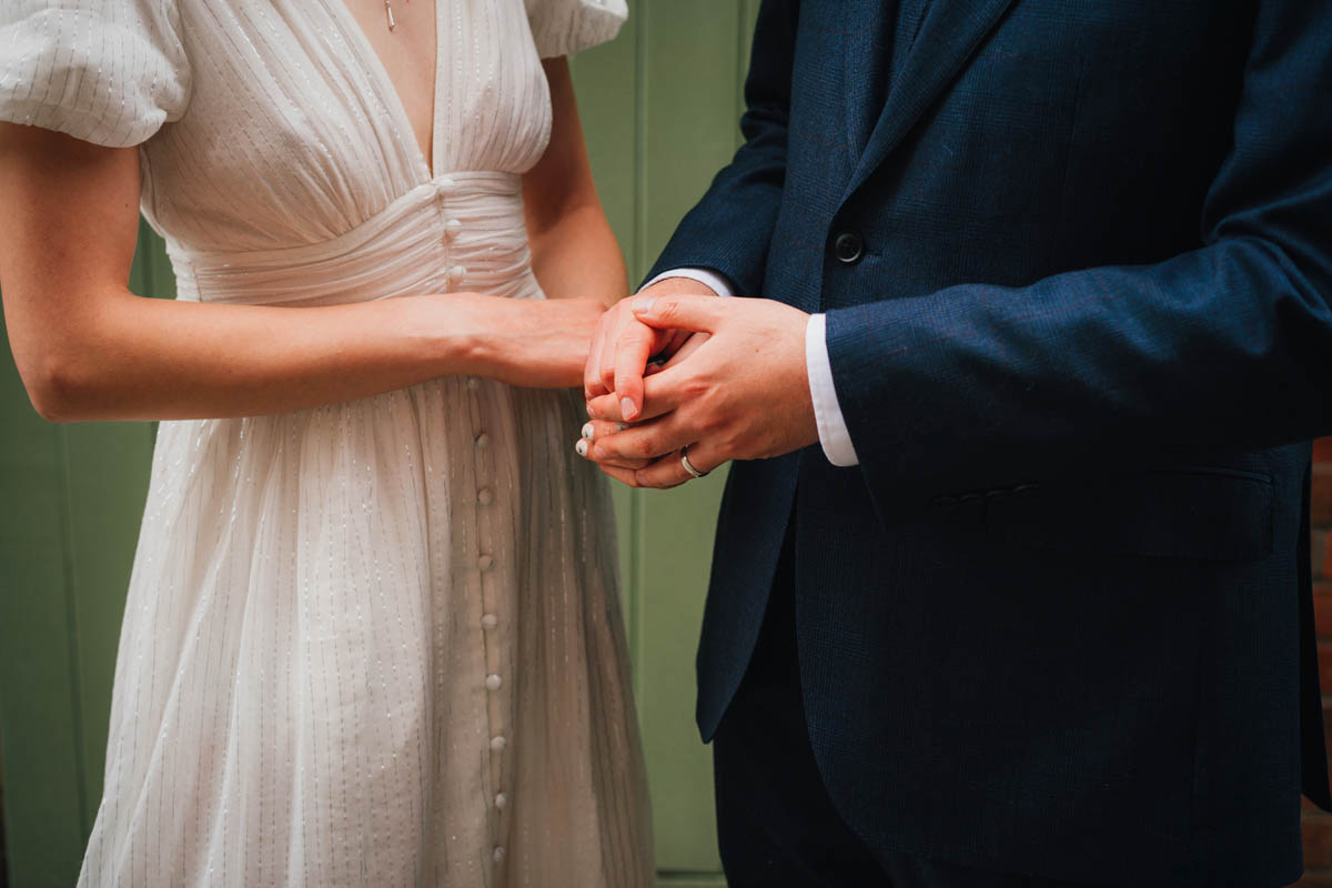 close-up on the bride and groom's hands