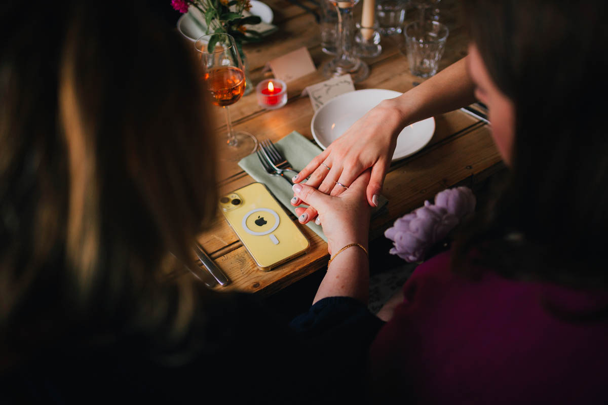 a bridesmaid examines the bride's wedding ring