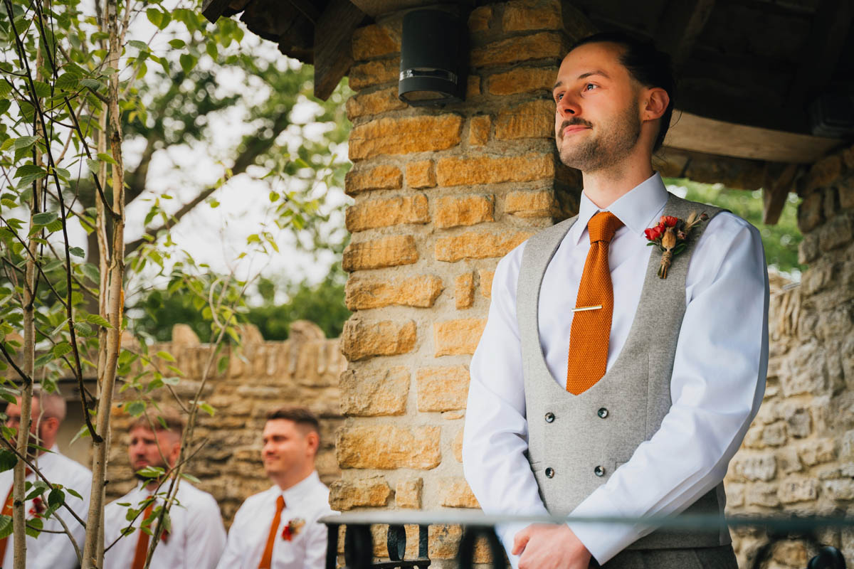 the groom's eyes are filled with tears as she awaits his bride's arrival