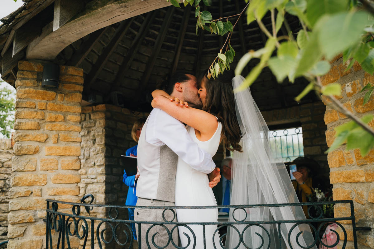 the bride and groom share their first kiss as husband and wife