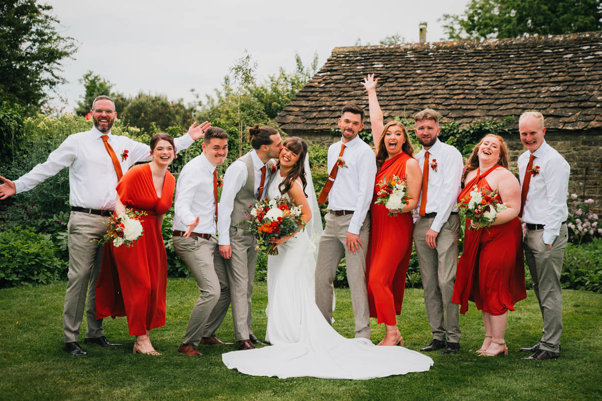 the bridesmaids and groomsmen pose for the camera