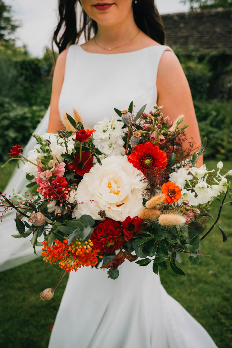 the bridal bouquet with marigolds, roses and eucalyptus