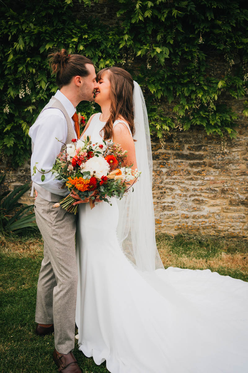 portrait of the bride and groom kissing