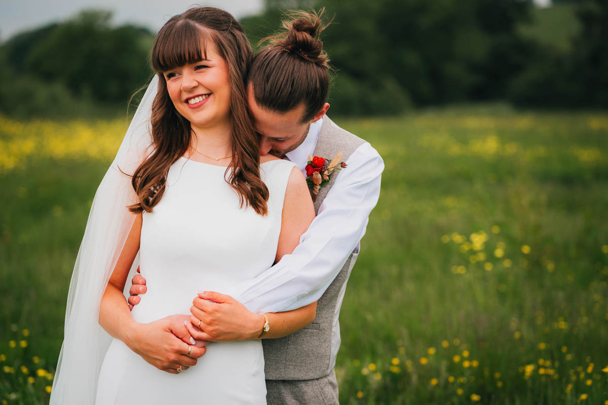 newlyweds portrait in a field of buttercups