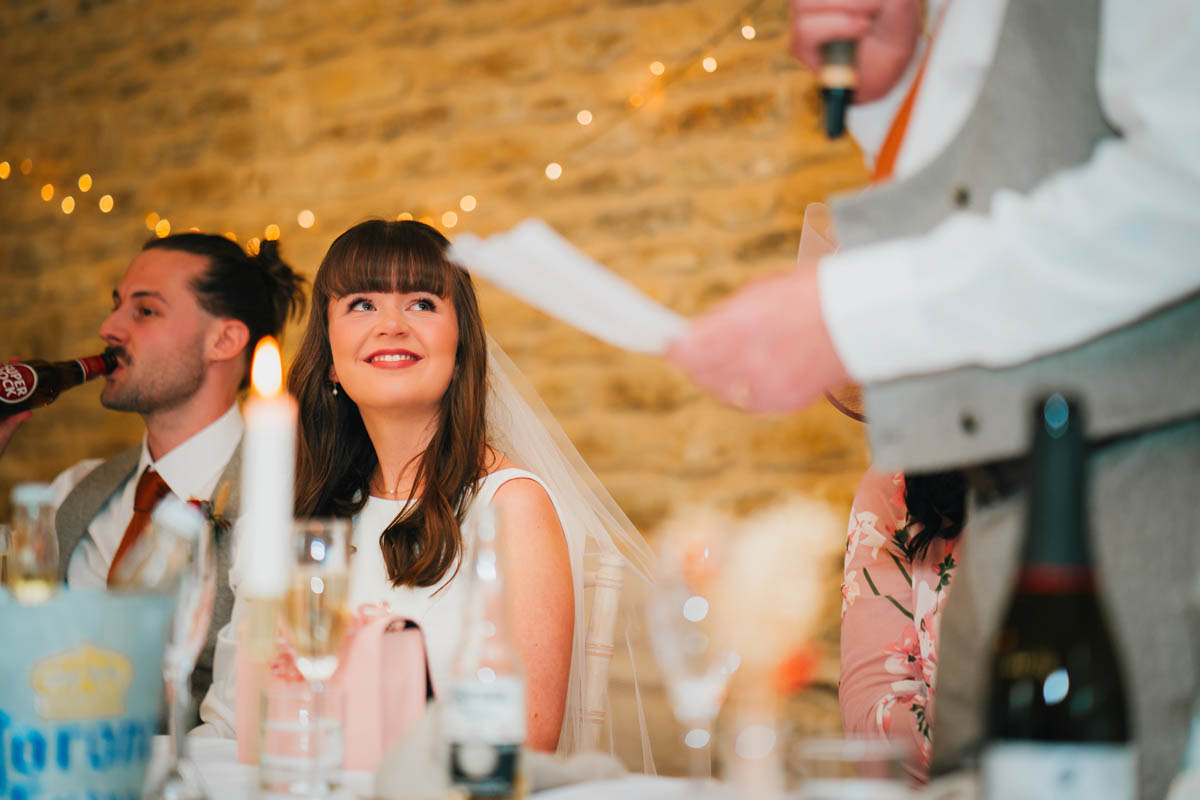 the bride looks up at her dad during his father of the bride speech