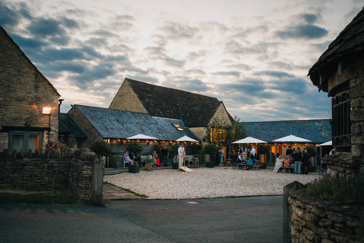 winkworth farm at dusk with wedding guests in the background