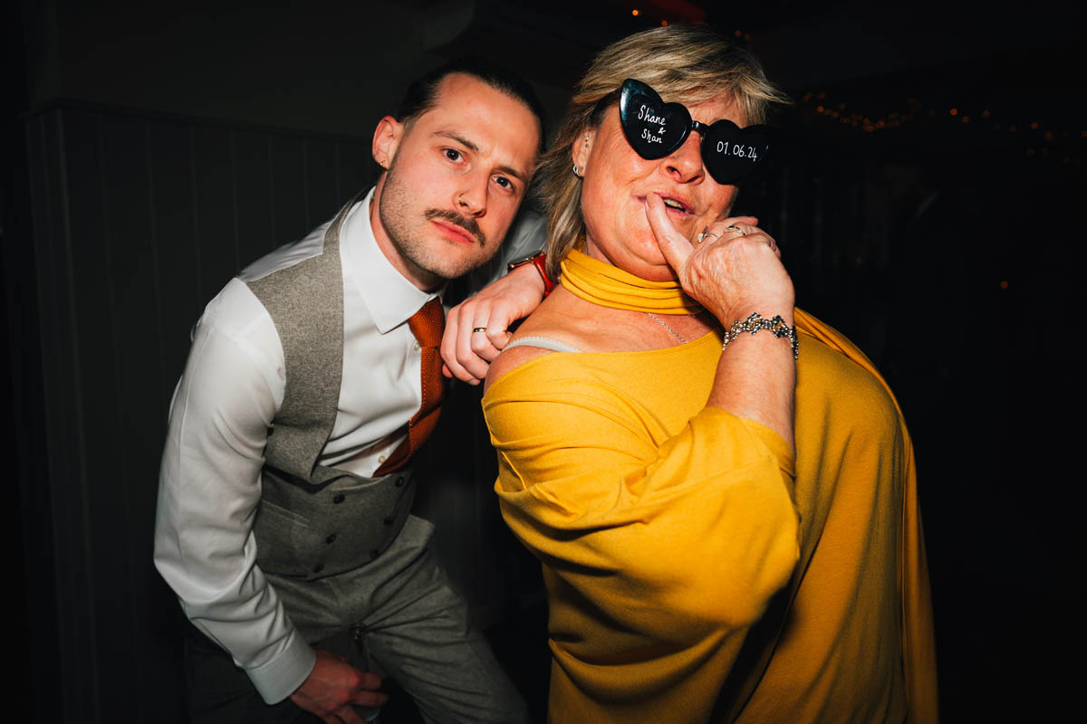 bride and his mother pose on the dance floor