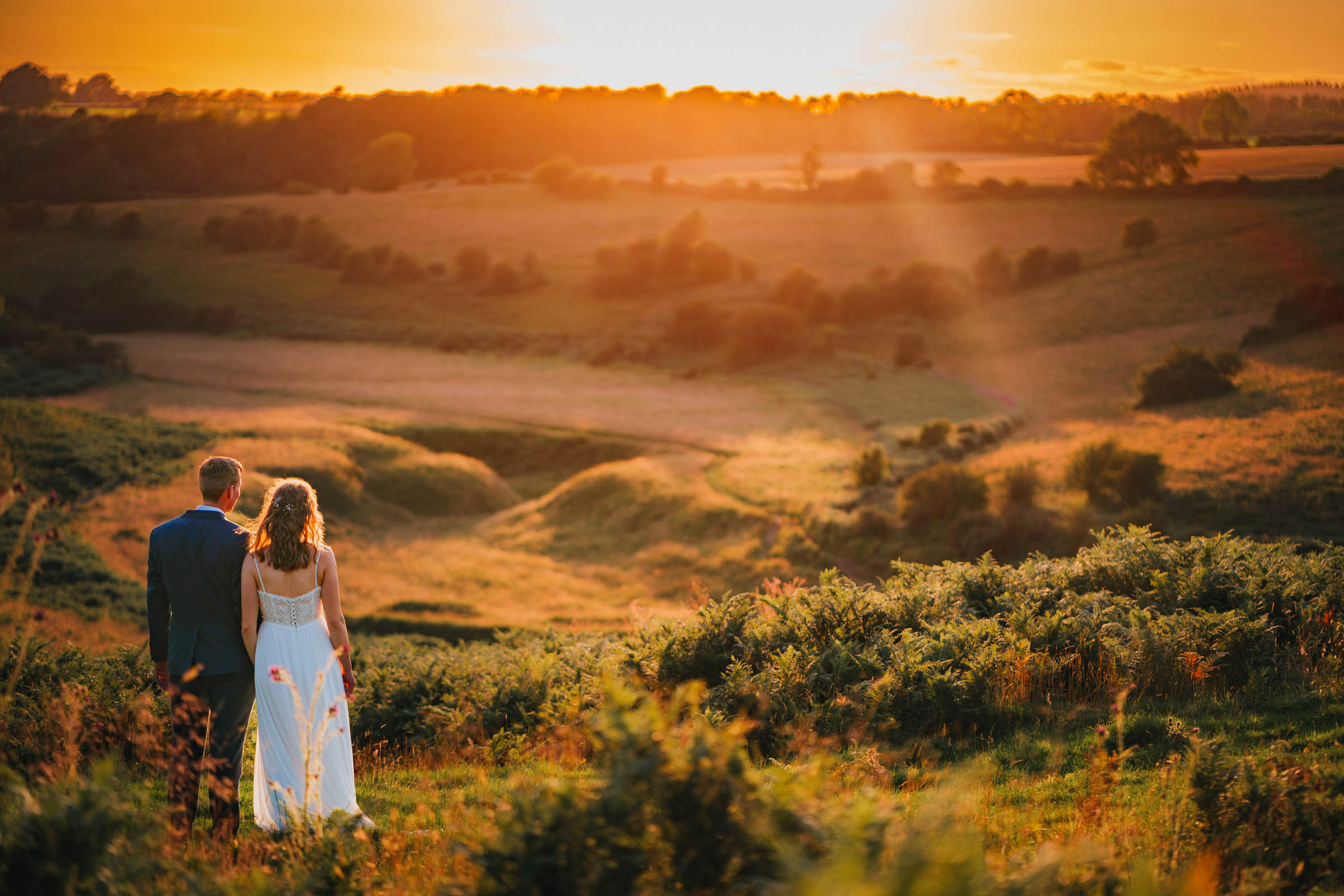 a bride and groom at golden hour overlooking the Mendip hills and views over Avon and Bristol