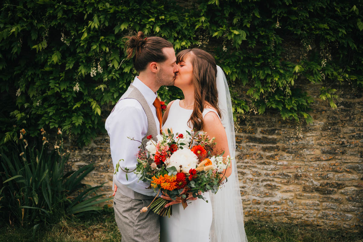 a groom kisses his new wife on their wedding day at a Bristol wedding venue