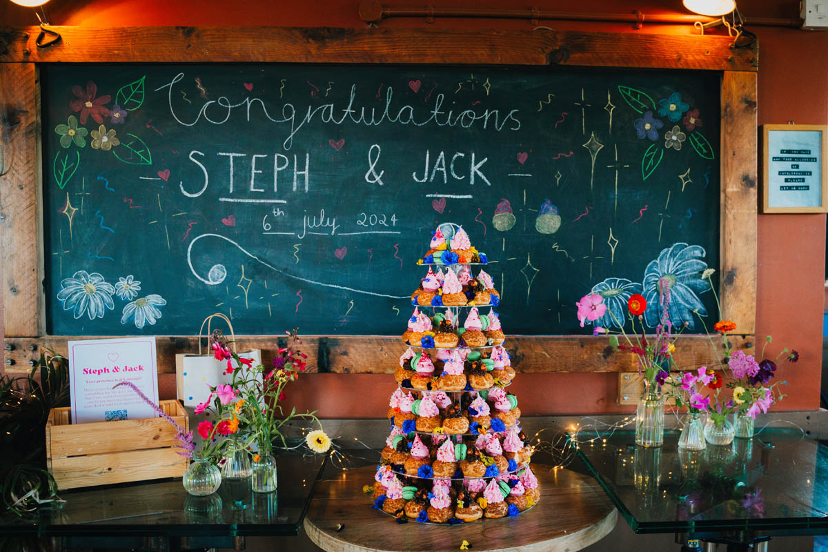 the cake and gift table at a mud dock wedding