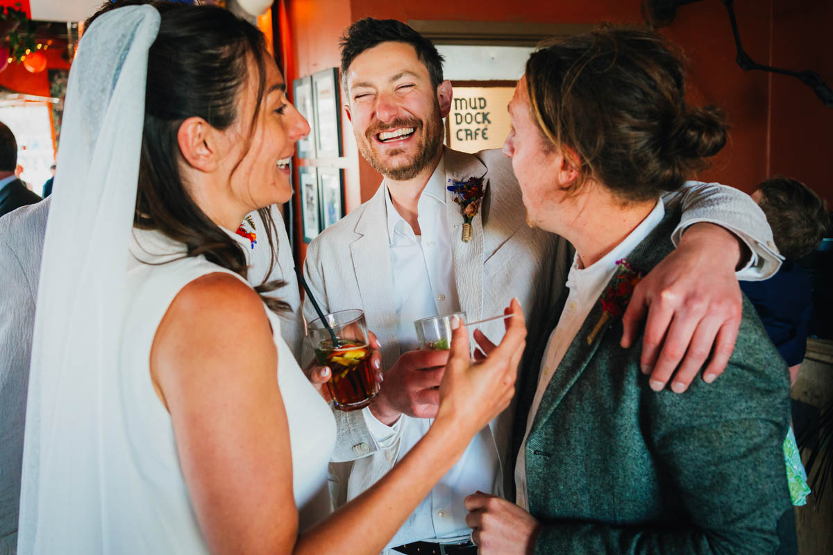 the groom hugs his friend and laughs