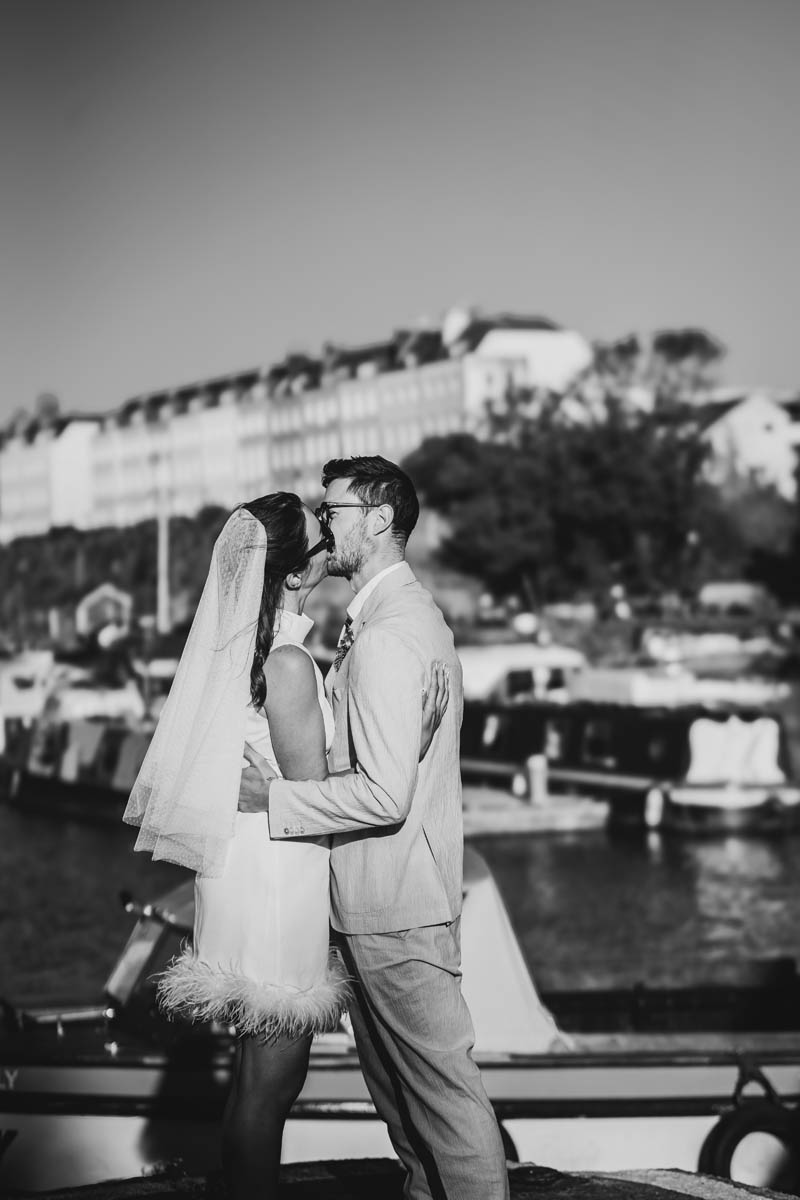 the newly-weds smile at each other and holds hands on Bristol Harbour