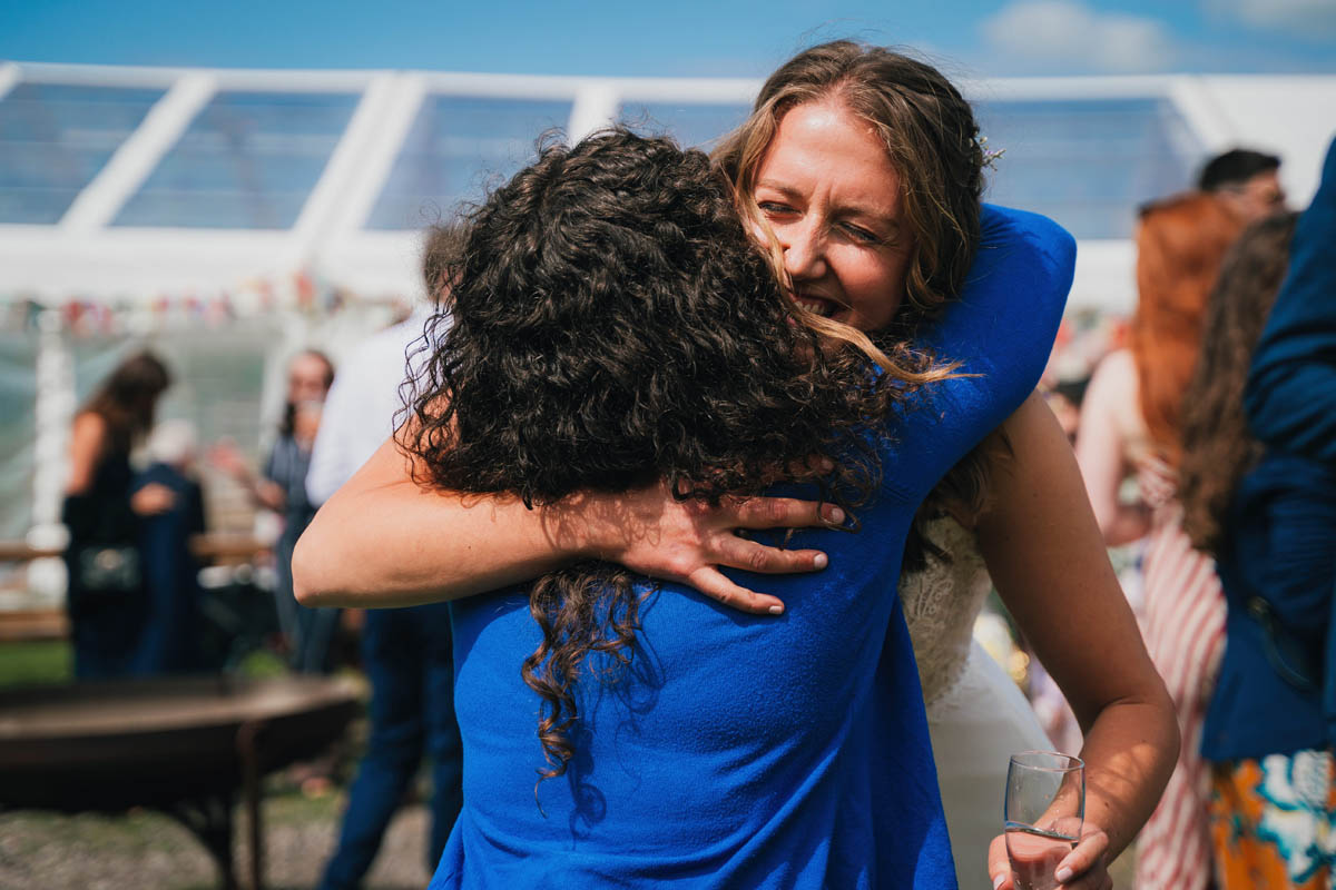 the bride excitedly hugs her friend