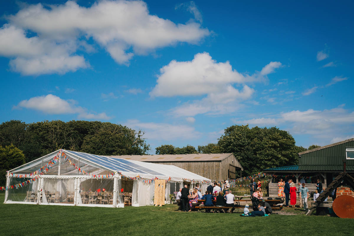 the marquee erected at warren farm with wedding guests enjoying the space