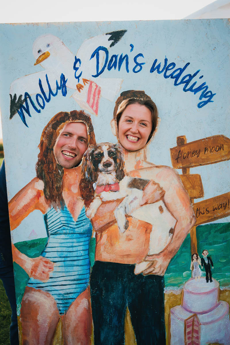 the bride and groom on their wedding day holding their pet dog