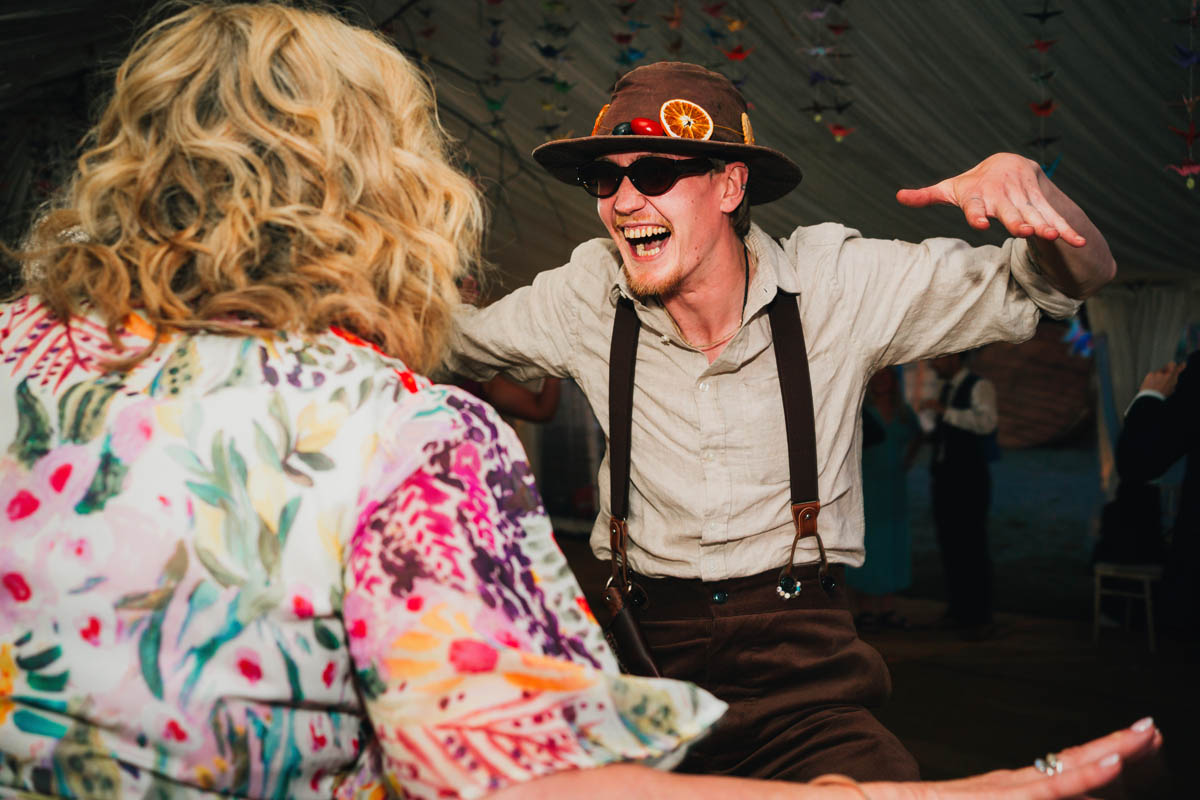 a man dances with a woman in a marquee wedding