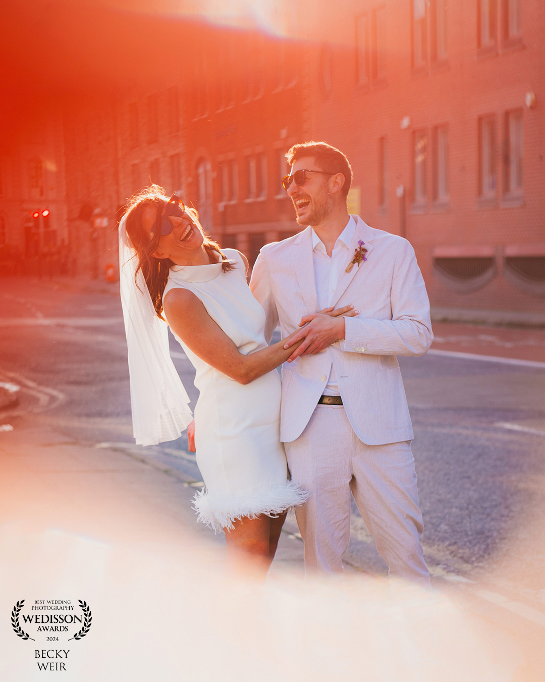 a newly-married couple at golden hour in Bristol city centre streets on their wedding day