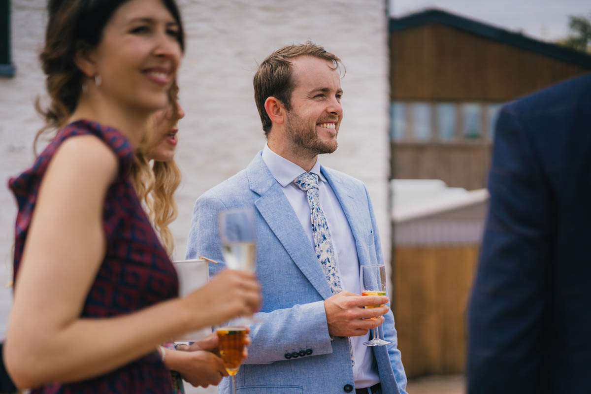 wedding guests enjoy pimms in champagne glasses