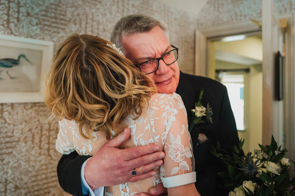 a man cries as he hugs a woman