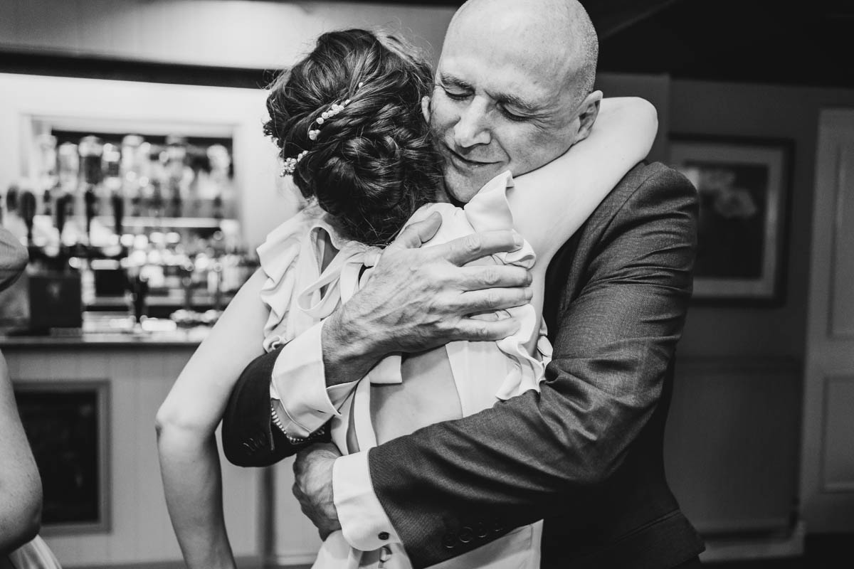 an emotional hug between a man and his daughter