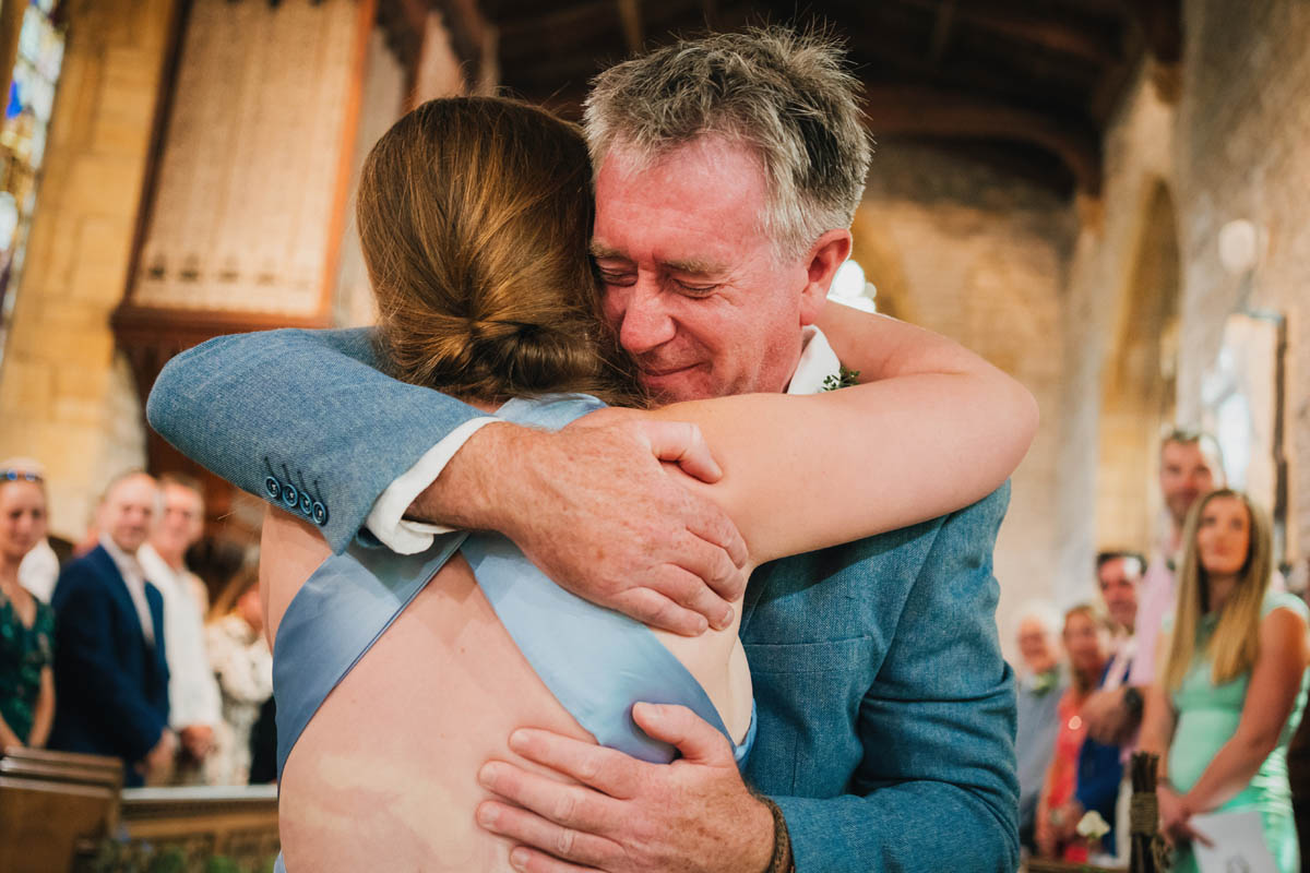 a man hugs a bridesmaid