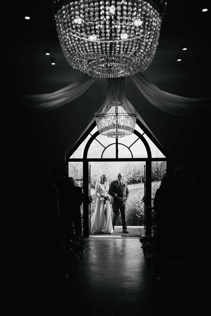 a father walks his daughter down the aisle