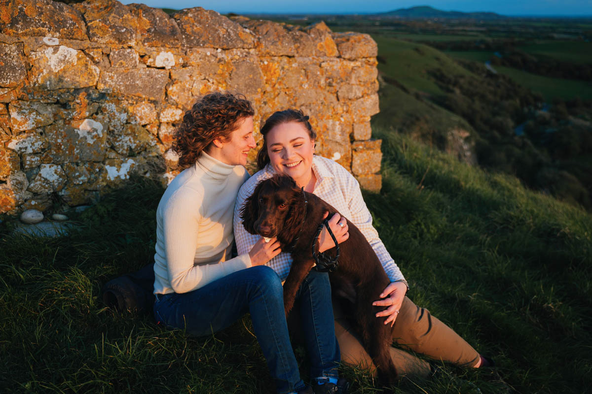 two brides cuddle their cocker spaniel