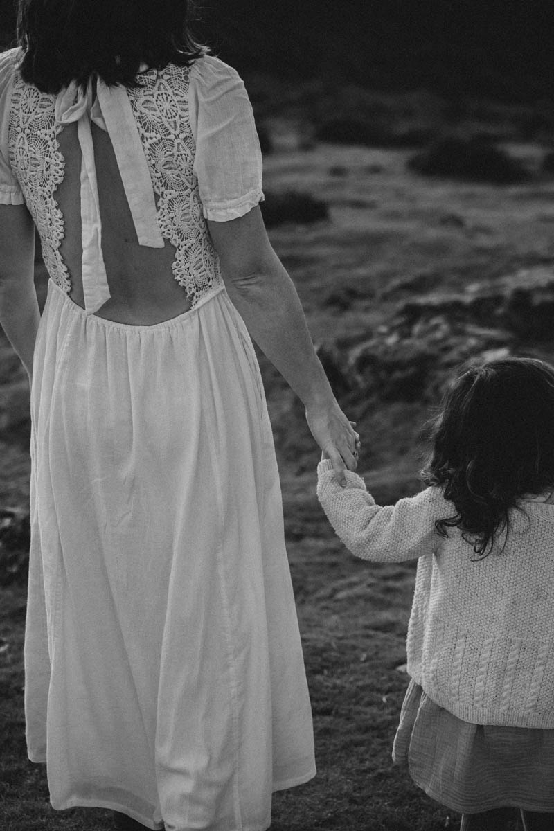 black and white of an adult holding a child's hand