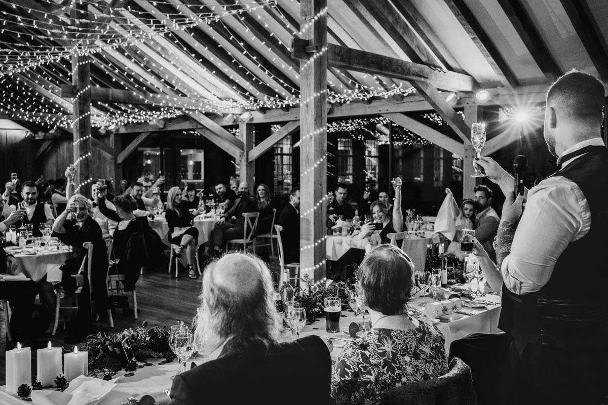 a man raises a glass in a toast during the speeches
