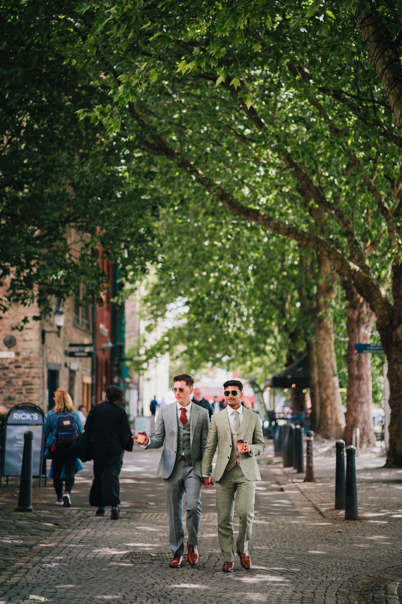 two grooms walk through Hereford's streets